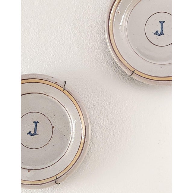 A pair of French earthenware plates, late 18th century.