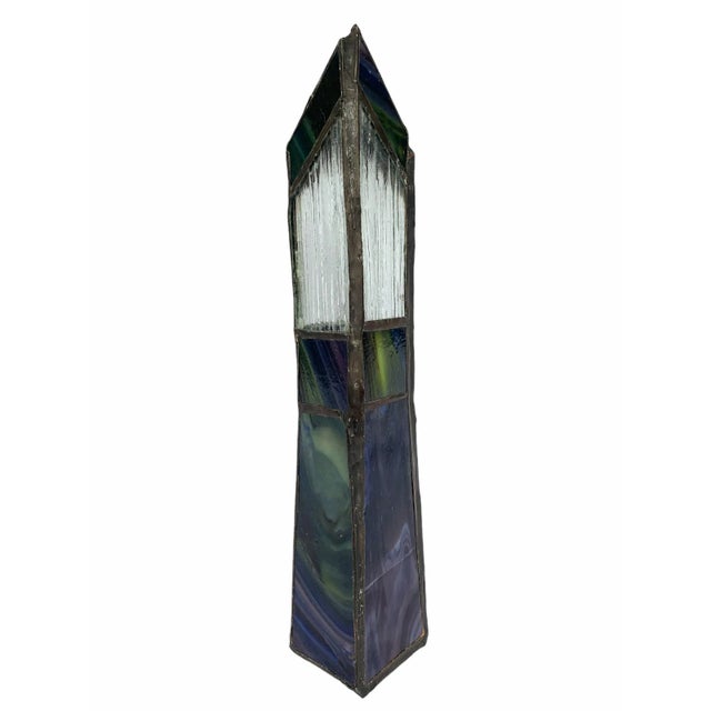 Early 20th century stained class vase in geometric shapes with tones of green and blue.