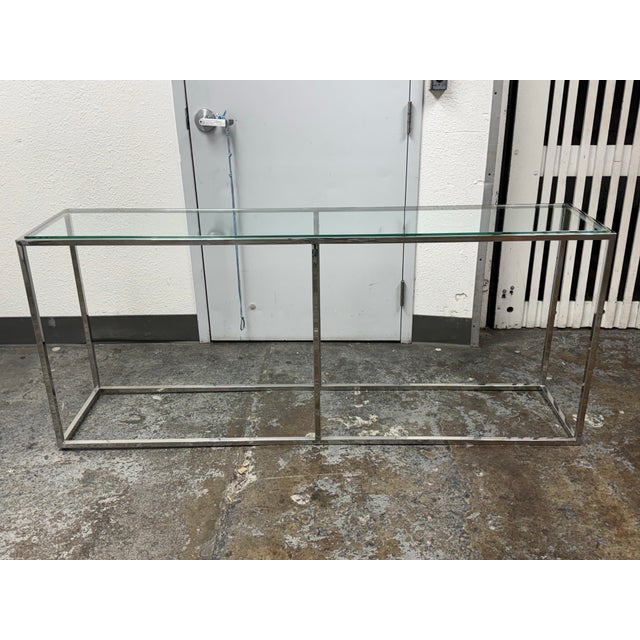 Design Plus Gallery presents a Modern Chrome + Glass Console Table. This contemporary console pairs a clear rectangular...