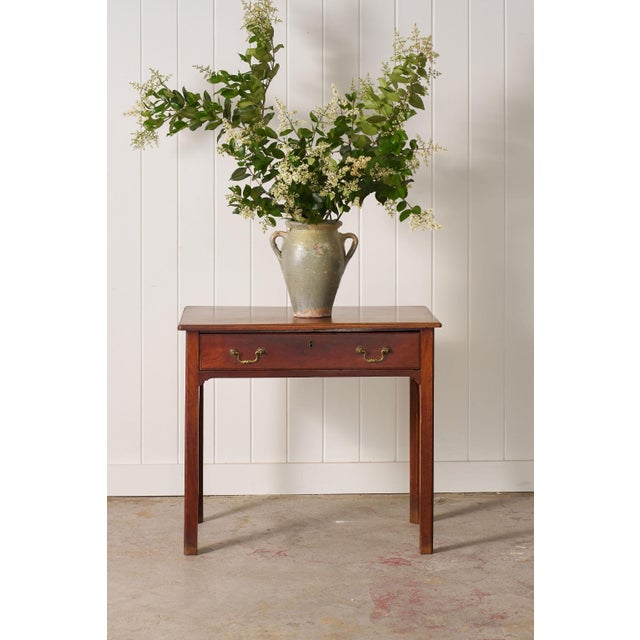 Georgian mahogany side table with a single drawer, square tapered legs, and pierced corner brackets. Original brass...