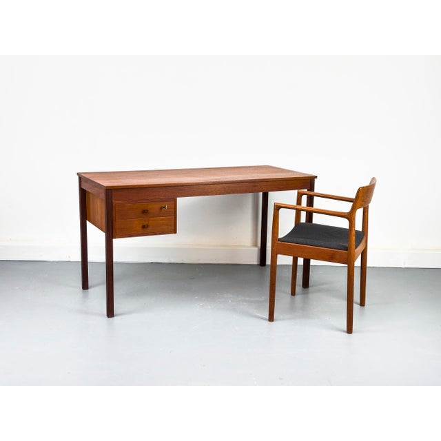 Danish teak desk with two drawers, the upper one lockable. A clean, timeless design with an elegant look. The drawers are...