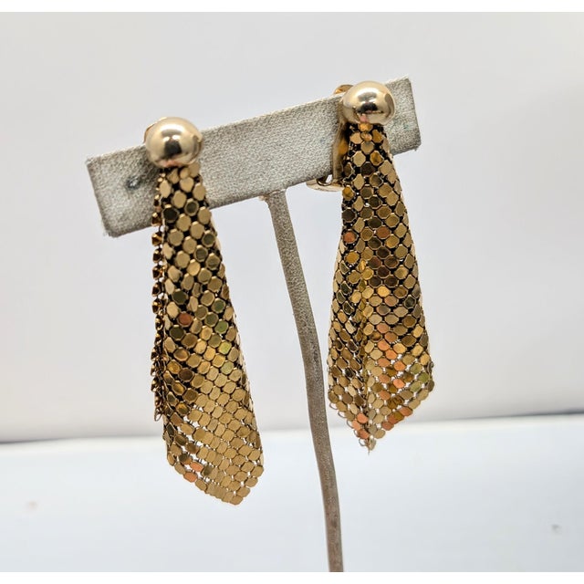 1970s goldtone round domed tops with mesh drops clip earrings. Marked "NAPIER PAT. PEND." on the clips and at the bases of...