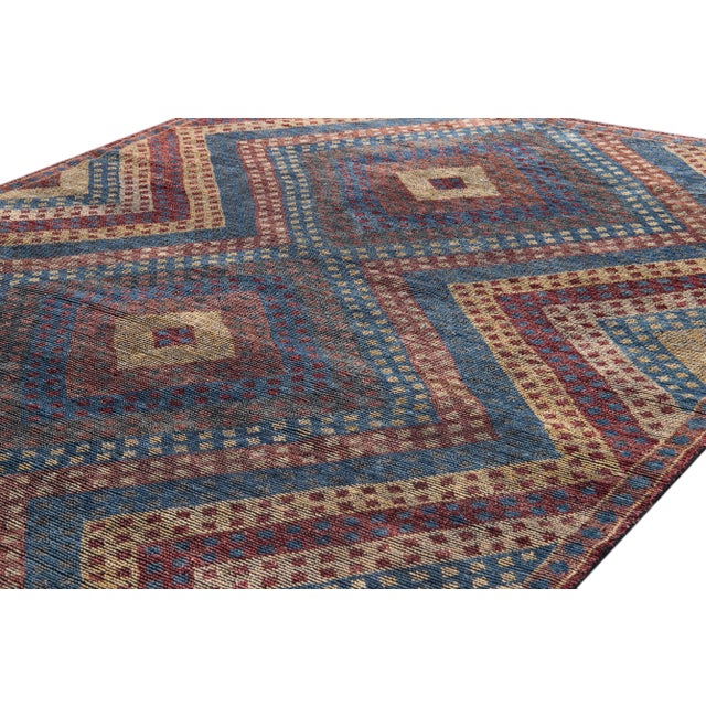 Beautiful contemporary Soumak style distressed Indian rug, hand-knotted wool with a blue, dark yellow, and red field in an...