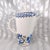 This is a white Nueva San Isidro coffee pot with a blue patterned rim and blue floral design. It is from Mexico and I do...