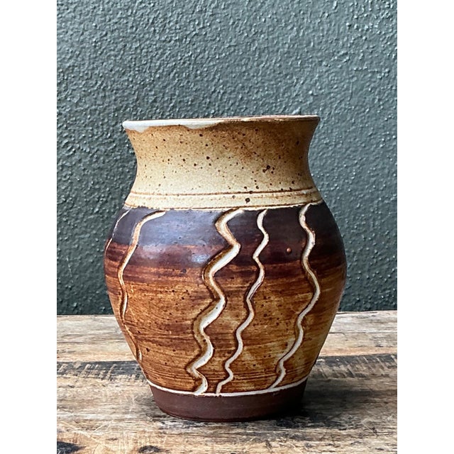This vintage handcrafted stoneware vase beautifully showcases the artistry of mid-century studio pottery through its...