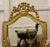 Dramatic Gilt-wood French Wall Mirror The Mirror has a simple carved gilt Frame set with a basket of flowers at the top...