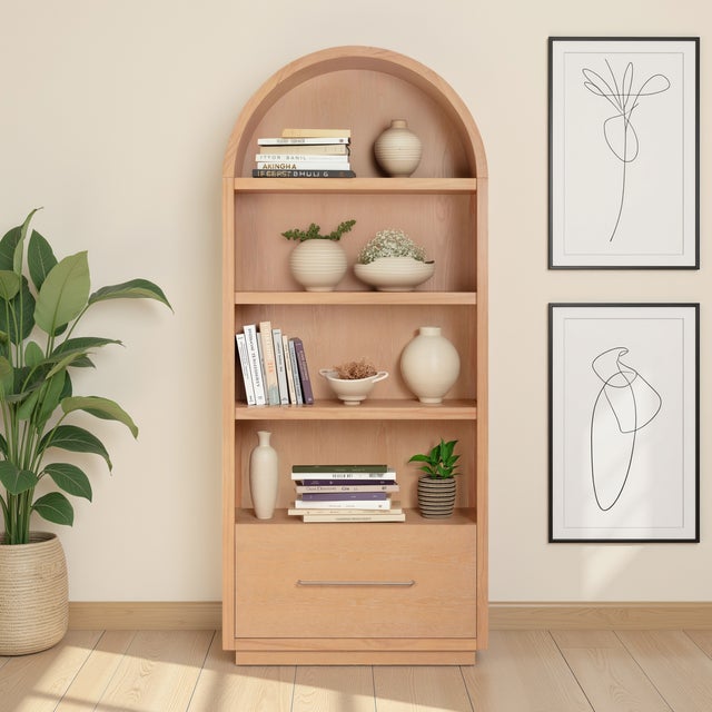 The Marlow Bookcase with File Drawer blends sculptural form with practical storage. Its soft curves, open shelving, and...