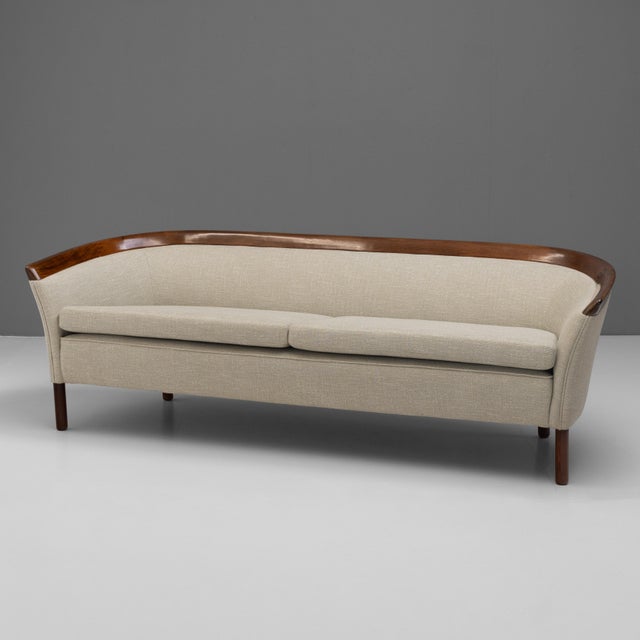Mid-Century Danish curved sofa newly upholstered with a polished back rail in teak. Denmark circa 1960.