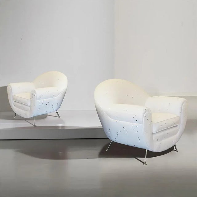 Pair of Mid-Century Italian Lounge chairs. These stylish newly upholstered armchairs feature a rounded shape with a wool...