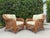 A handsome pair of Palm Beach style wicker lounge chairs featuring substantial rolled arms, open lattice sides and backs,...