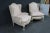 Louis XV Style carved wingback bergere chairs in light pink upholstery with carved cream frame.