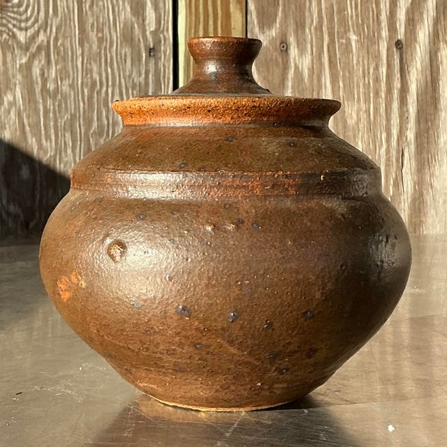 This Vintage Boho Studio Pottery Lidded Urn is a stunning example of artisanal craftsmanship, blending functionality with...