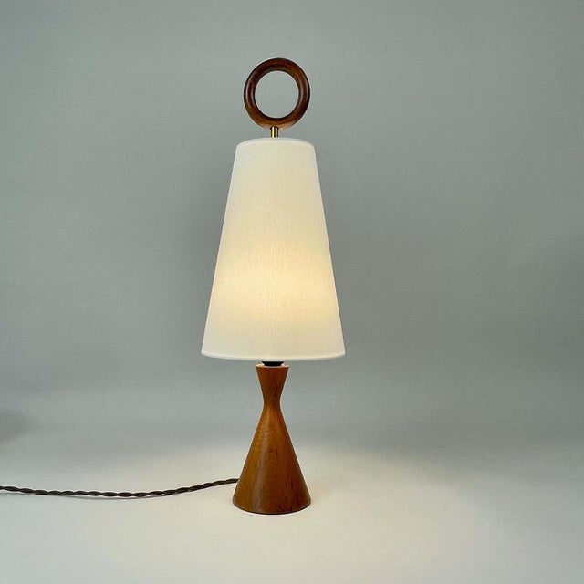 This mid-century table lamp was designed and manufactured in sweden in the 1960s. The light features a sculptural wooden...