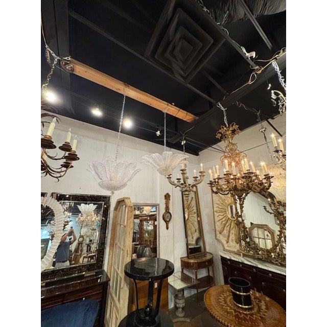 The Murano Granola Glass Palm Leaf Flush Mount Chandelier is a stunning home decor piece that adds a touch of elegance and...