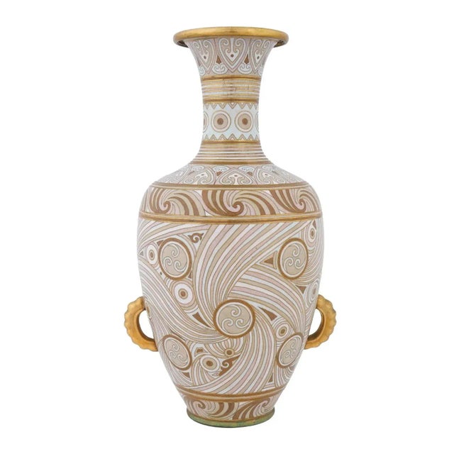 An early 20th century Chinese copper vase with cloisonne enamel decor. Bottle shape. Swirl ornamental design in beige...