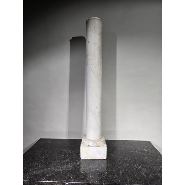 This elegant 19th-century column crafted from white Carrara marble from Italy is a piece of great beauty and refinement....