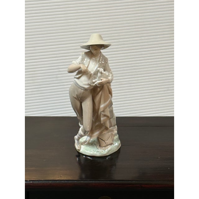 Design Plus Gallery presents the Porcelain Figurine Lladró Shepherd Boy with Lamb by Juan Huerta for Lladró. This is a...