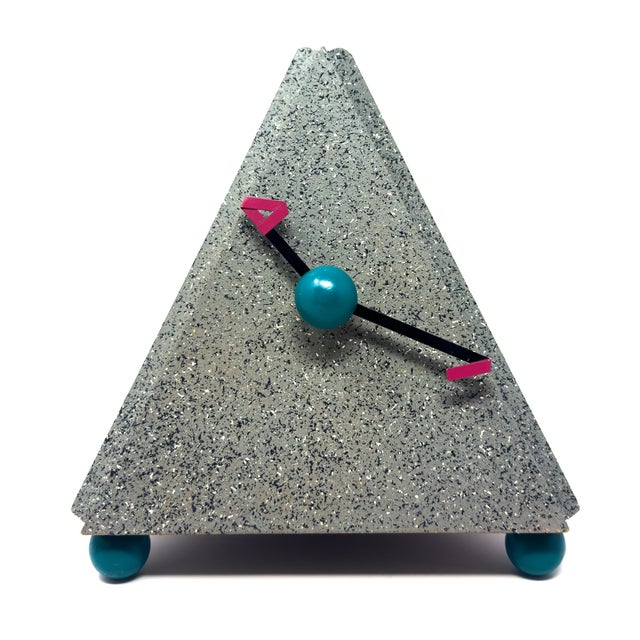 A textbook piece of late-1980s postmodern design: a solid triangular form finished in grey splatter paint flecked with...