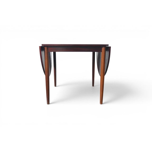 A beautifully grained rosewood drop leaf dining table from Denmark, 1960s. Compact and versatile, it closes to just 28.5"...