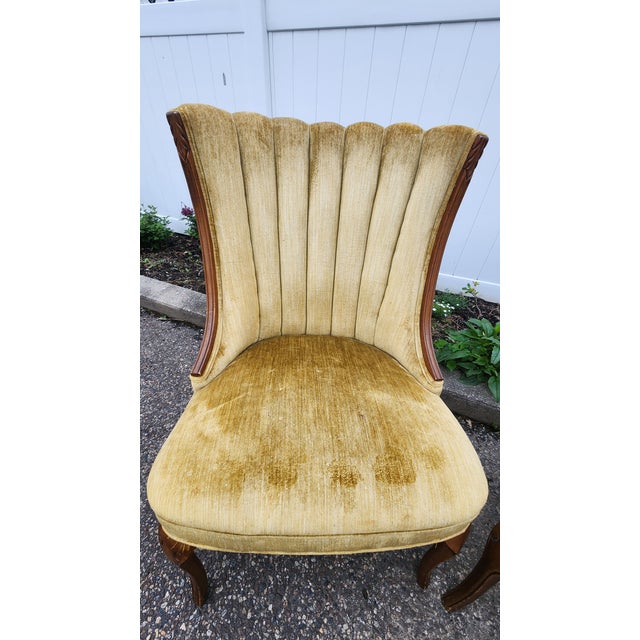 Elegant pair of vintage Hollywood Regency slipper chairs featuring dramatic fan-shaped channel backs, exposed carved wood...