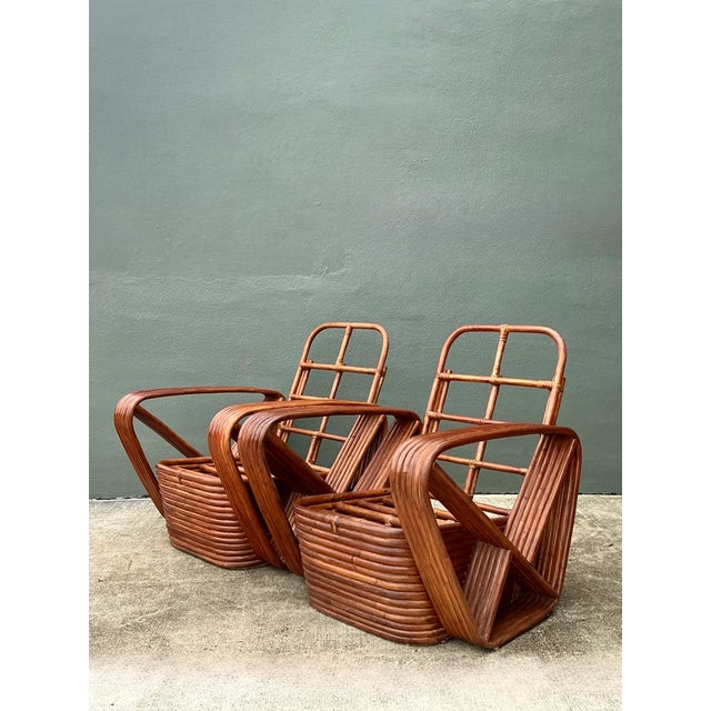These vintage Paul Frankl six-strand rattan lounge chairs bring mid-century modern character to a room through their...