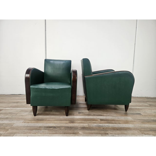 An elegant pair of Italian Art Deco armchairs dating back to the 1940s, characterized by a minimalist design and soft,...