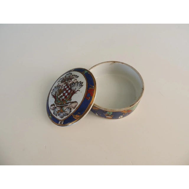 Round Hand-Painted Chinese Export Box With Lid Depicting a Coat-Of-Arms Size:5"D x 2.5"H Hand painted in Macau.