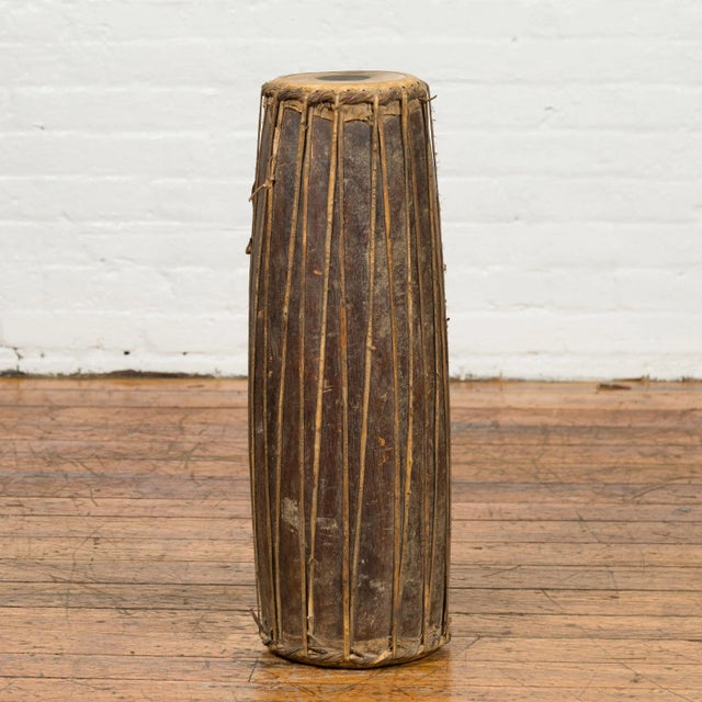 An antique Indonesian wooden drum with leather drumhead. Sculptural and freestanding, this antique Indonesian drum will...