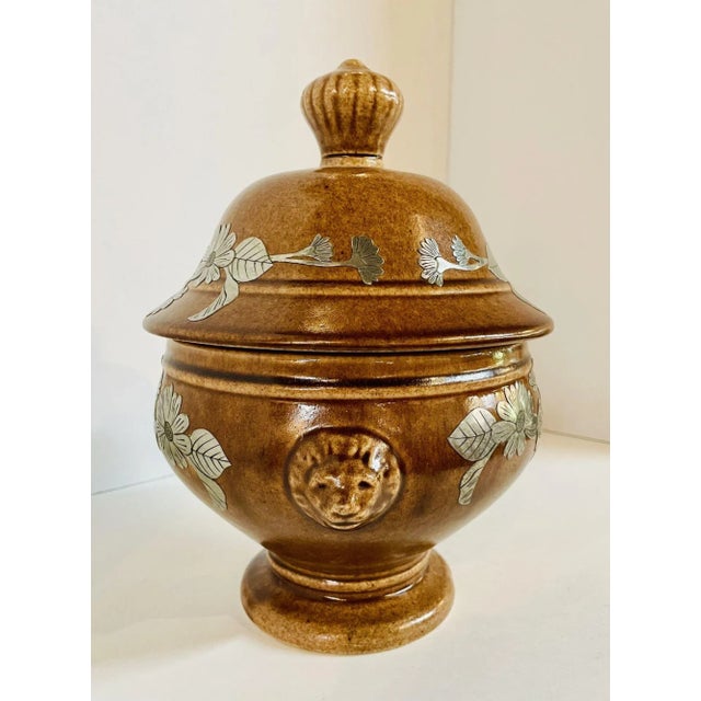Beautiful brown Mid-Century pottery urn with artisan hand crafted florals in pewter. Intricate details. Dimensions: 11...