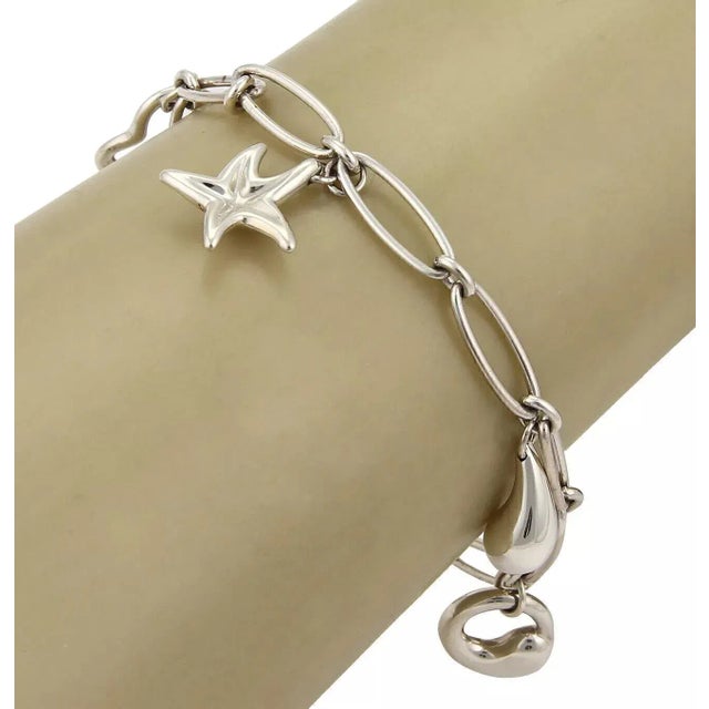 Material: sterling silver Hallmark: Tiffany & Co. Elsa Peretti 925 Measurement: 7.25" long x 0.21" wide Charms are: varies...