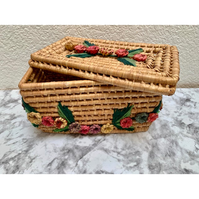 Vintage woven decor and storage basket with woven texture and whimsical floral patterned accents.
