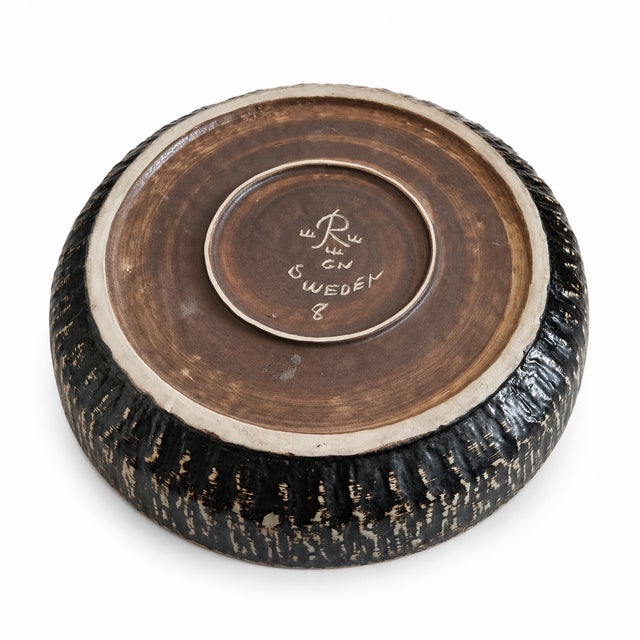 A studio stoneware bowl by Gunnar Nylund, designed and produced at Rörstrand in Sweden during the mid-20th century. The...