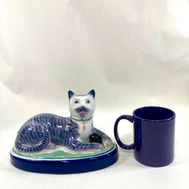 Wonderful recumbent mantle cat painted in blueish gray colors. I love the ball in his front paws. Nice large size that...