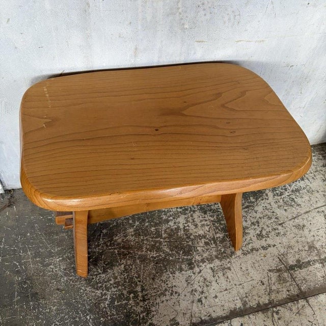 A characterful mid-century brutalist elm side table, featuring sculptural wooden supports, exposed pegged joinery and a...