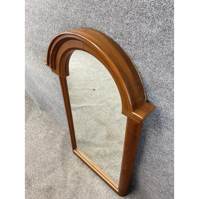 A beautiful antique walnut and burl wood arched wall mirror, dating to approximately the 1920s, with a substantial...