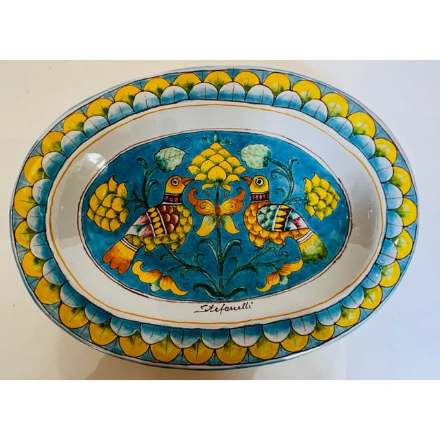 Color extrodianair! Fabulous azure blue and bright sunny yellow brighten up the love bird and artichoke platter. This has...