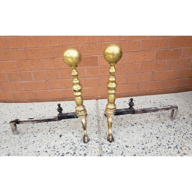 A Pair of Early 20th Century George III Style Solid Brass Canon Ball Andirons. Meaures 11" in width, 17" in depth and...