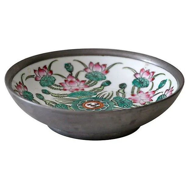 A lovely encased dish. Features a floral scene with turquoise, greens and pinks. The silver encasing has a beautiful...