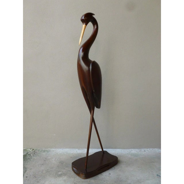 Life size 1970's hand carved wood flamingo or crane with glass eyes standing 60 inches high refinished and ready to place...
