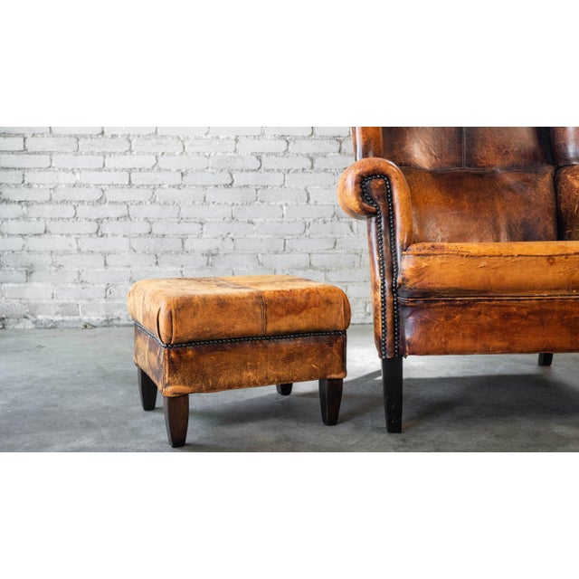 1970s 1970s Vintage Art Deco Distressed Cognac Leather Wingback Chair & Ottoman For Sale - Image 5 of 16
