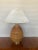 A pear shaped lamp in the style of Gabriella Crespi, c.1970s. It is clad in pencil reed, with a brushed brass base, stem...