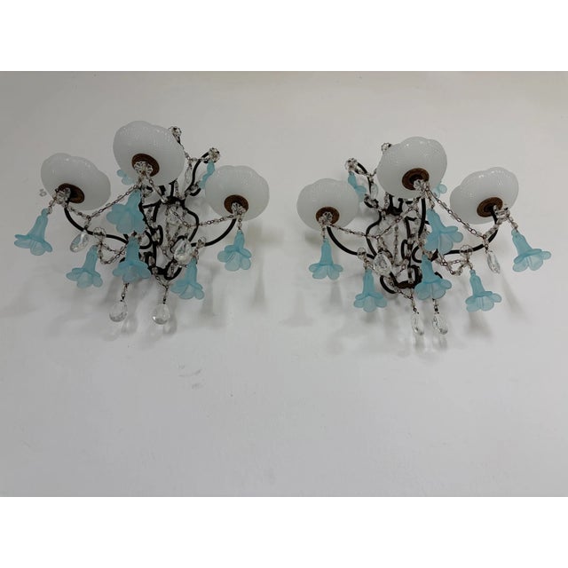 Beautiful one of a kind rare set of sconces housing three lights each, sitting in crystal bobeches dripping with vintage...