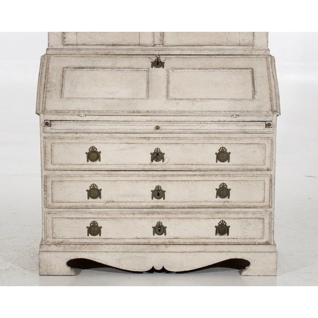 This two-part swedish bureau, made circa 1790 and featuring original hardware and locks, contains various interior...
