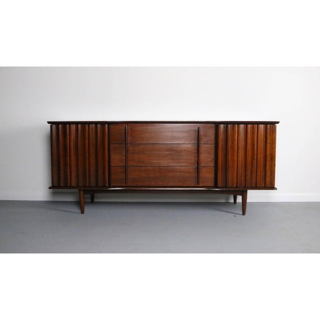 This is a an absolutely stunning one of a kid mid century modern credenza / TV console. This lovely piece is attributed to...