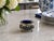 A charming vintage silverplate footed vessel with cobalt blue glass insert, featuring richly detailed floral repoussé...