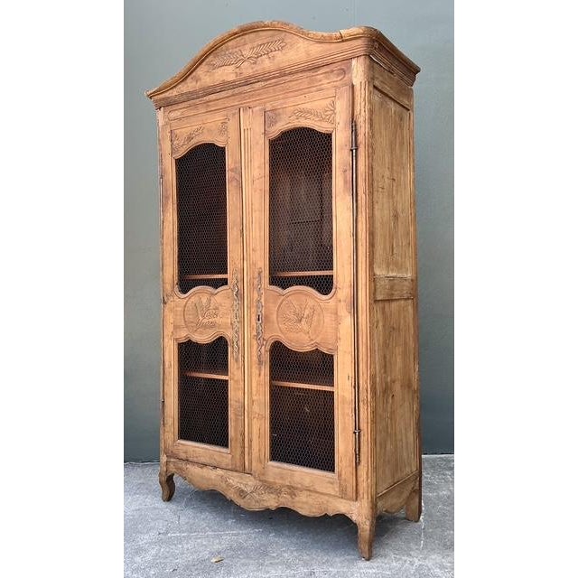 Elevate your interior with the rustic elegance of this vintage Gustavian-inspired armoire. This piece masterfully blends...