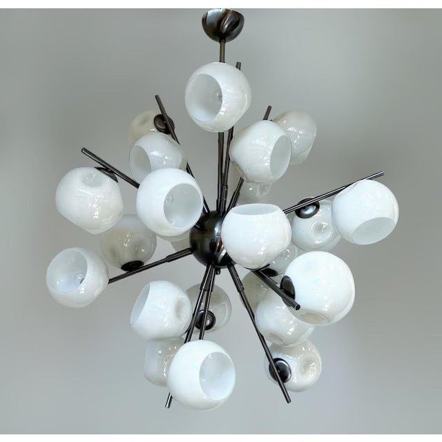 Italian modern sputnik chandelier with cream colored Murano glass shades mounted on metal frame in satin black nickel...