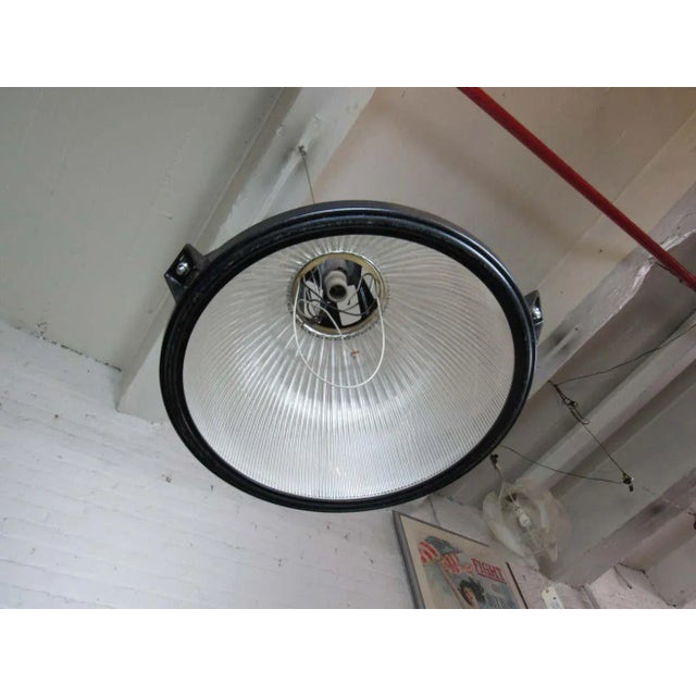 A heavy-duty industrial hanging lamp perfect for any shop or workspace. onc WEAR Wear consistent with age and use. Minor...