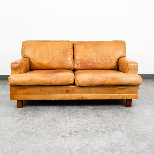 High quality caramel / cognac leather Danish modern 2 seater sofa / Settee by Vatne Mobler, Denmark . This piece was...