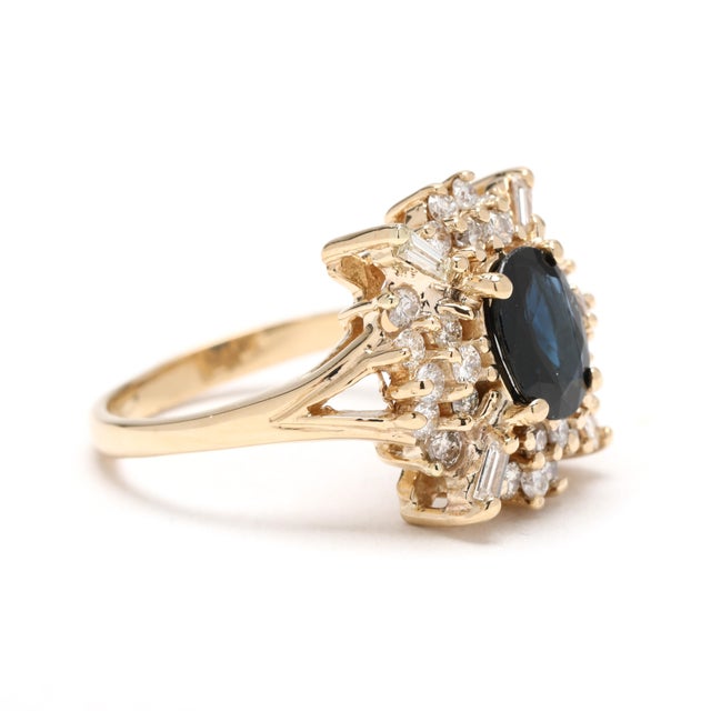 Stones: sapphire, 1 oval 8 x 6 mm approximately 1.7 carat diamond round brilliant, 28 stones 1.2 mm approximately .28...